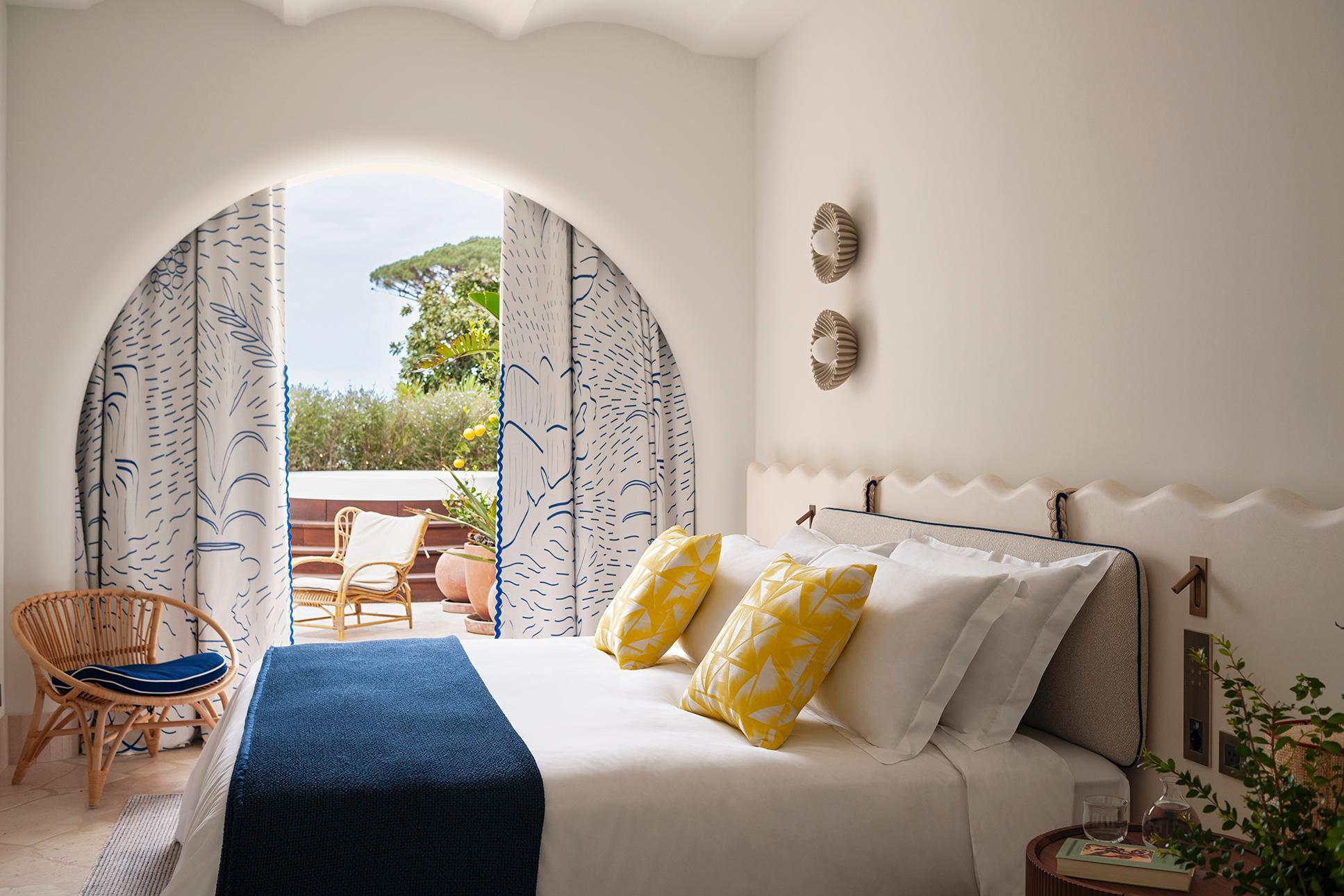 Deluxe Suite Pool Side featuring elegant white-on-white Caprese design and private garden terrace
