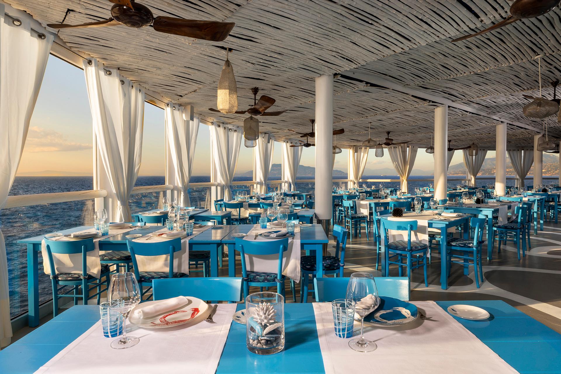 Il Riccio Restaurant & Beach Club perched dramatically on the cliffside above the Blue Grotto