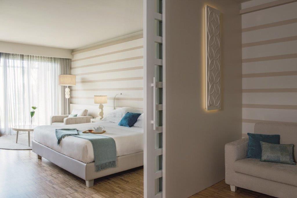 Exclusive Suite with natural Italian walnut, olive wood finishes, and expansive lake view