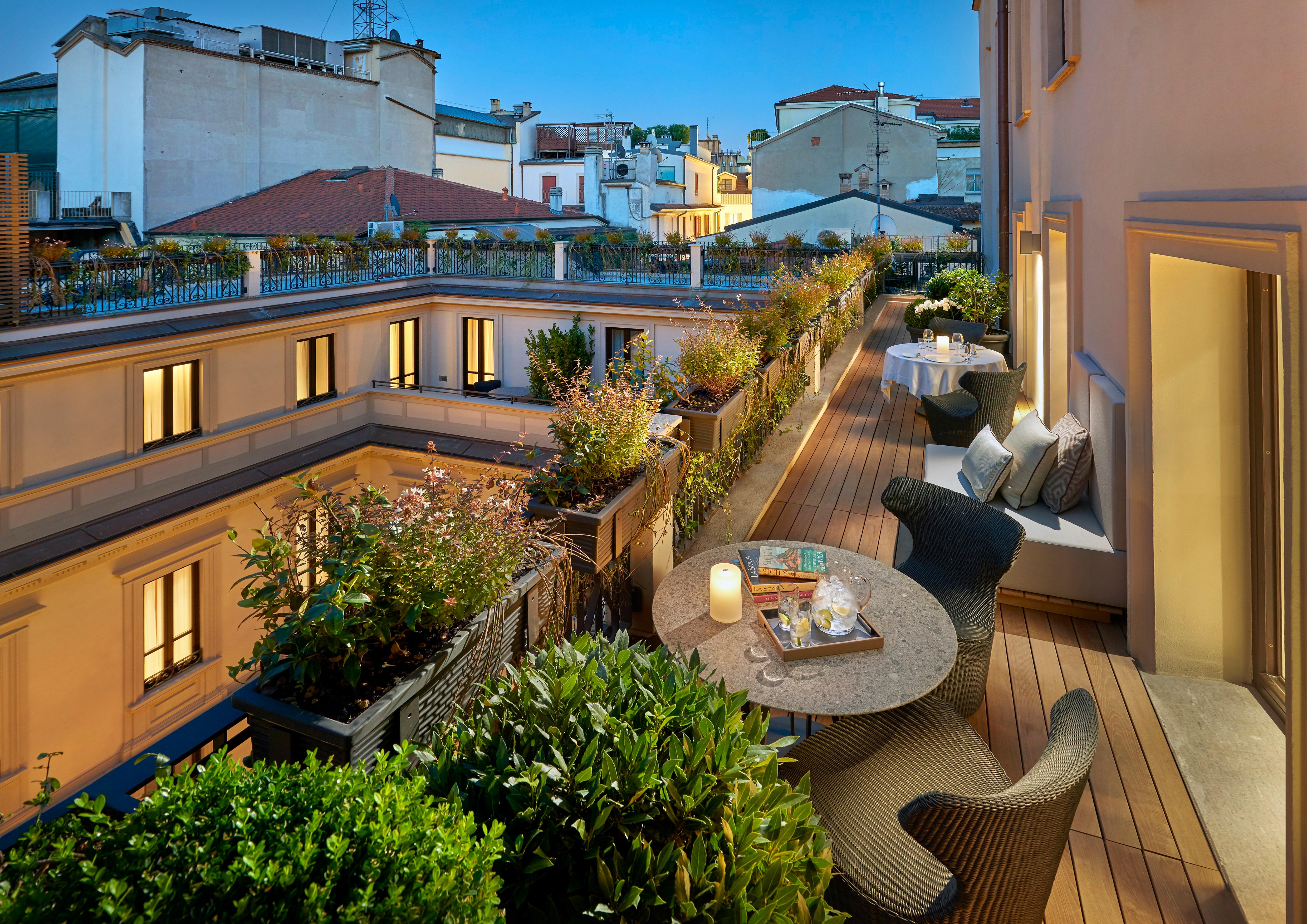 Private furnished rooftop terrace suite with panoramic views across Milan's rooftops