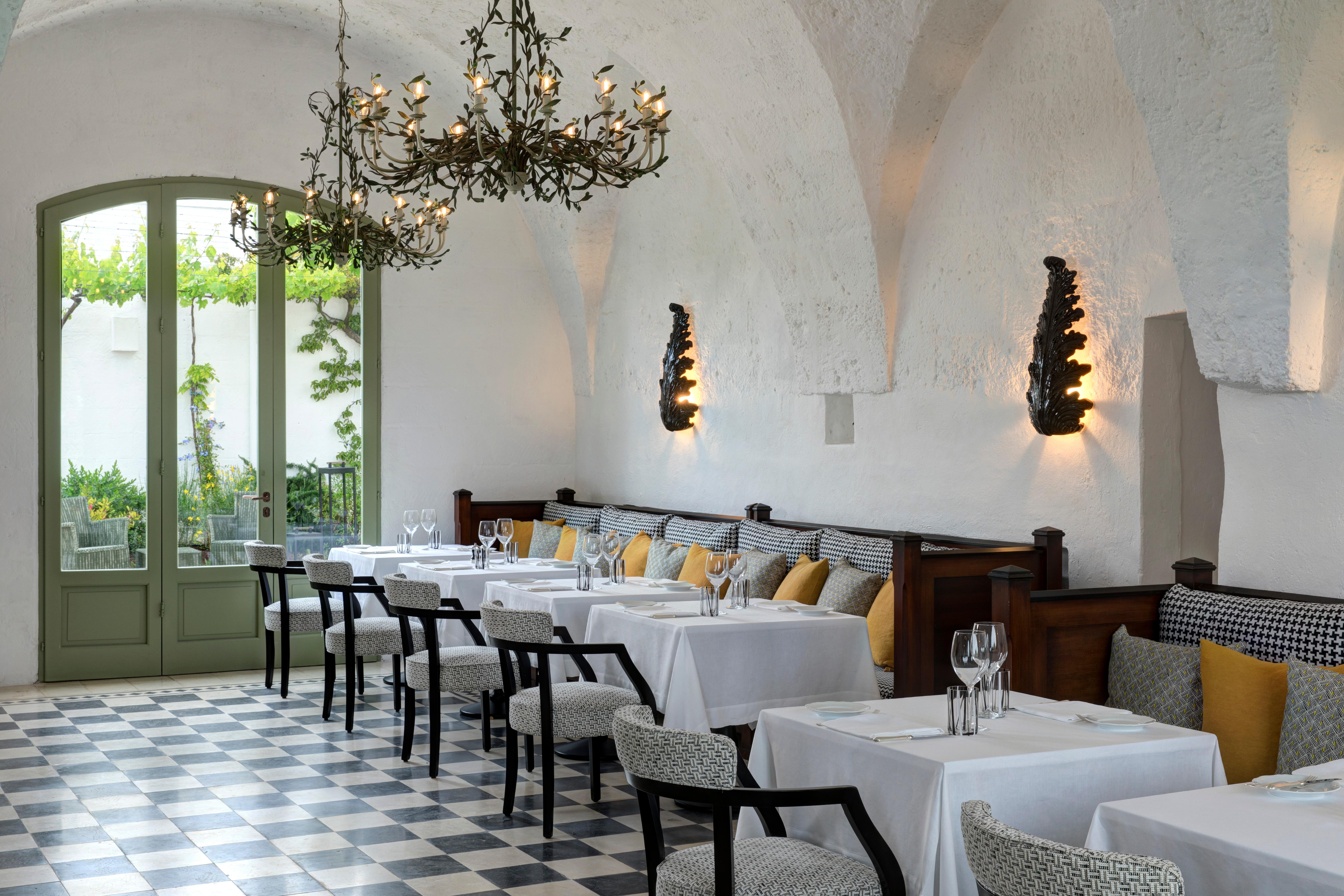 Ristorante Carosello set under traditional whitewashed barrel vaults overlooking citrus orchards