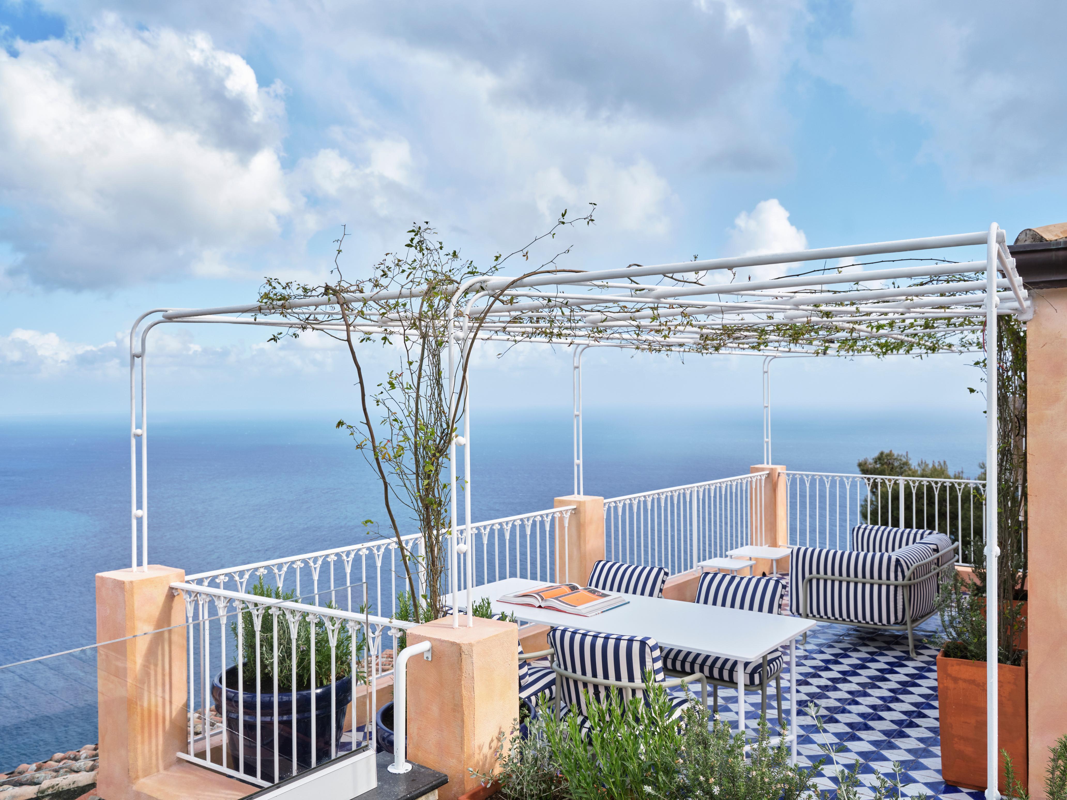 Infinito Suite terrace loungers with 180-degree coastal panorama