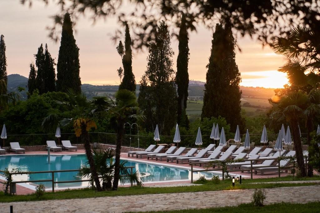 Precise Tale Poggio Alla Sala resort swimming pool overlooking rolling Tuscan hills and vineyards