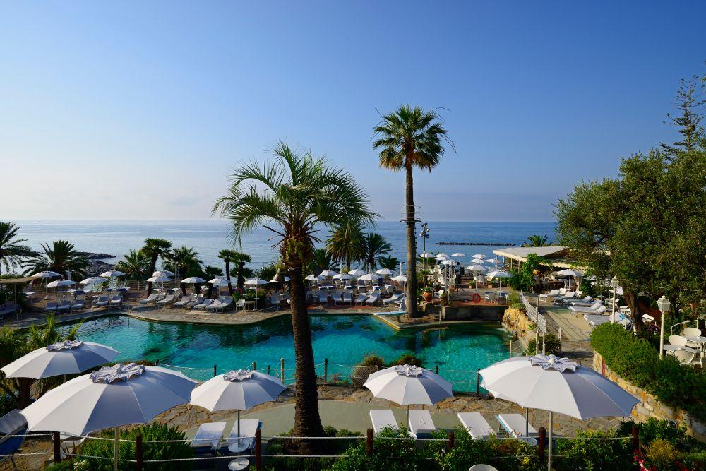 Freeform 27°C heated seawater pool designed by Gio Ponti in subtropical park