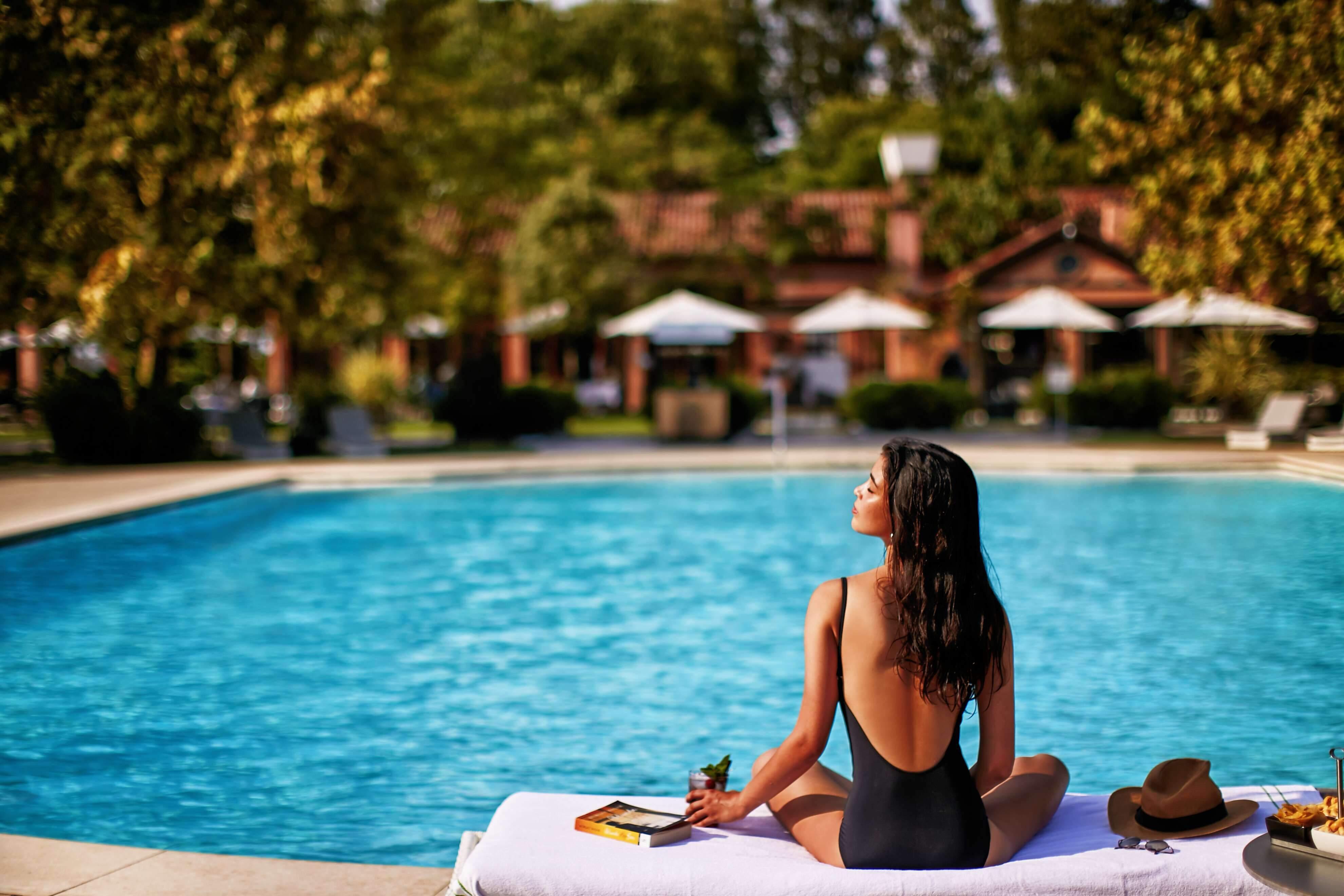 Heated outdoor pool surrounded by cypress gardens