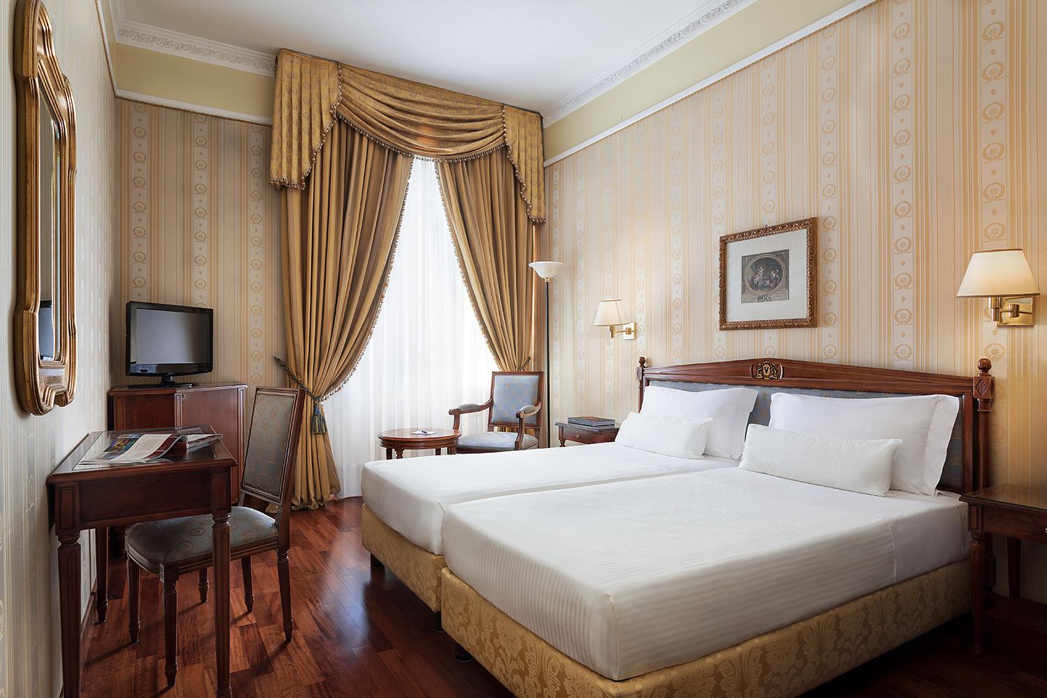 Spacious deluxe room featuring classic Italian design elements
