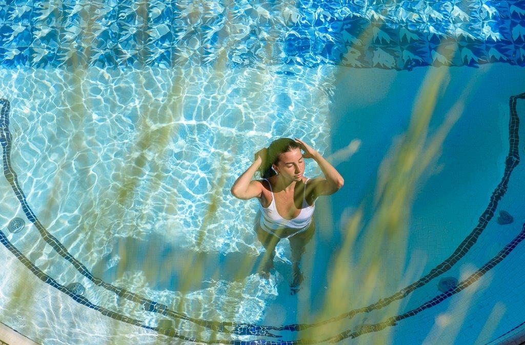 Outdoor swimming pool amidst rose gardens