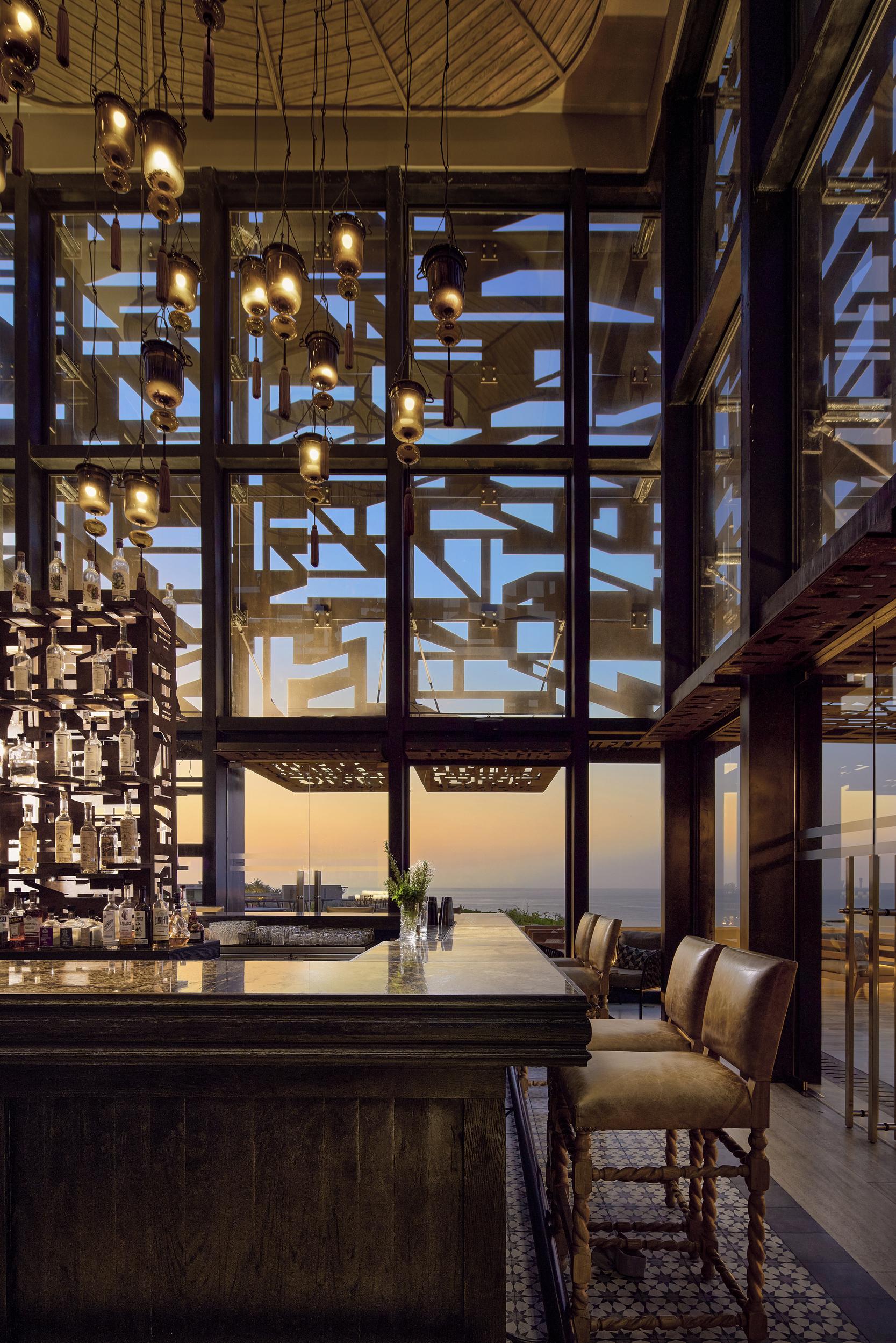 Candil agave bar featuring over 100 artisanal spirits and fire pit lounge
