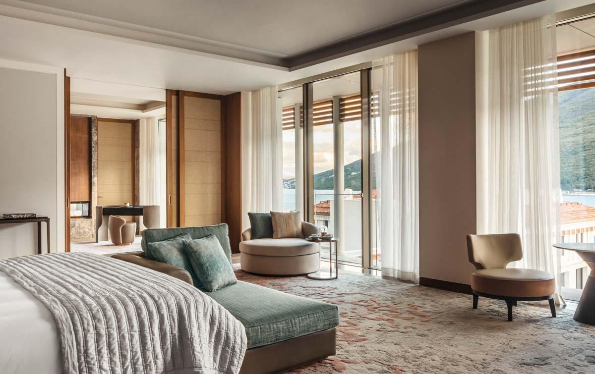 Signature Suite Bedroom with Sunset Vistas over Boka Bay and Double-Sided Fireplace