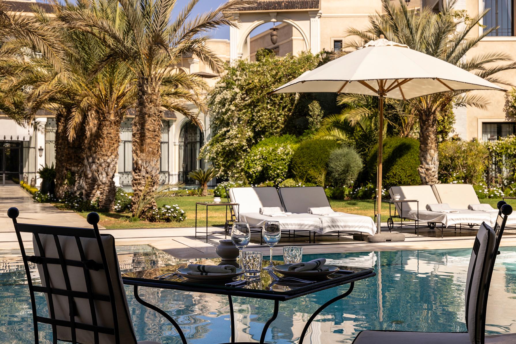 Heated Central Swimming Pool Flanked by Palm Trees