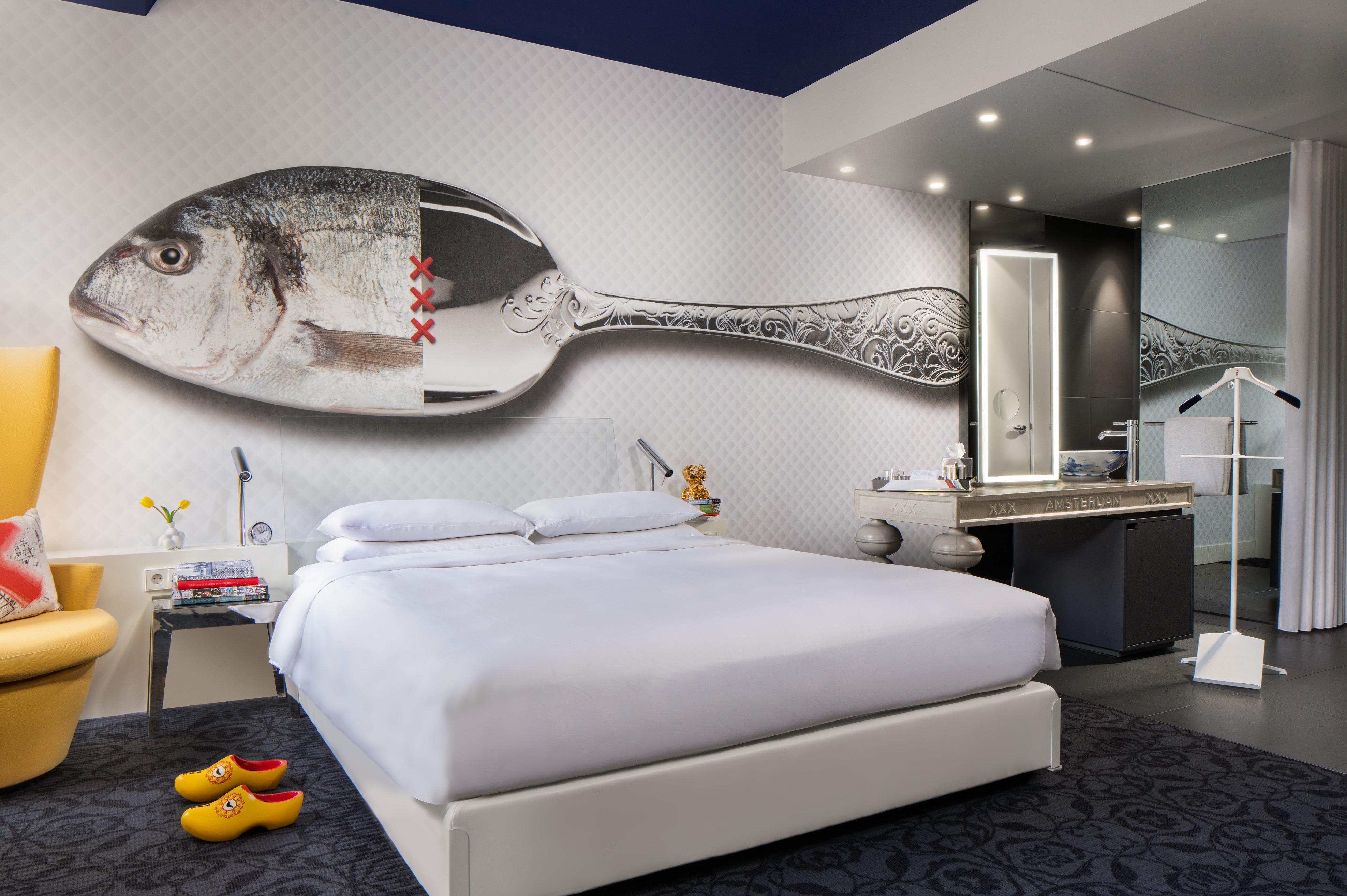 Canal View Guestroom with custom Delft blue wall murals and panoramic canal vistas