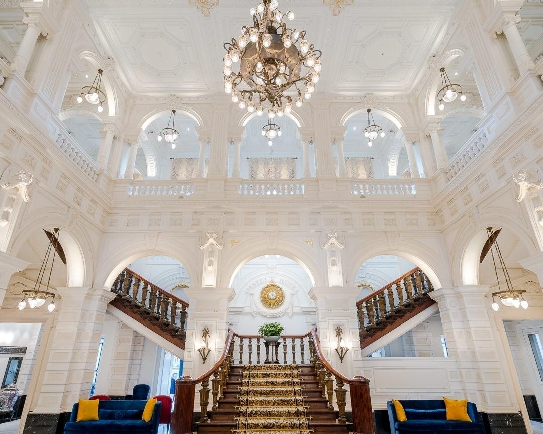 Monumental red-carpeted grand staircase and soaring lobby of InterContinental Amstel Amsterdam