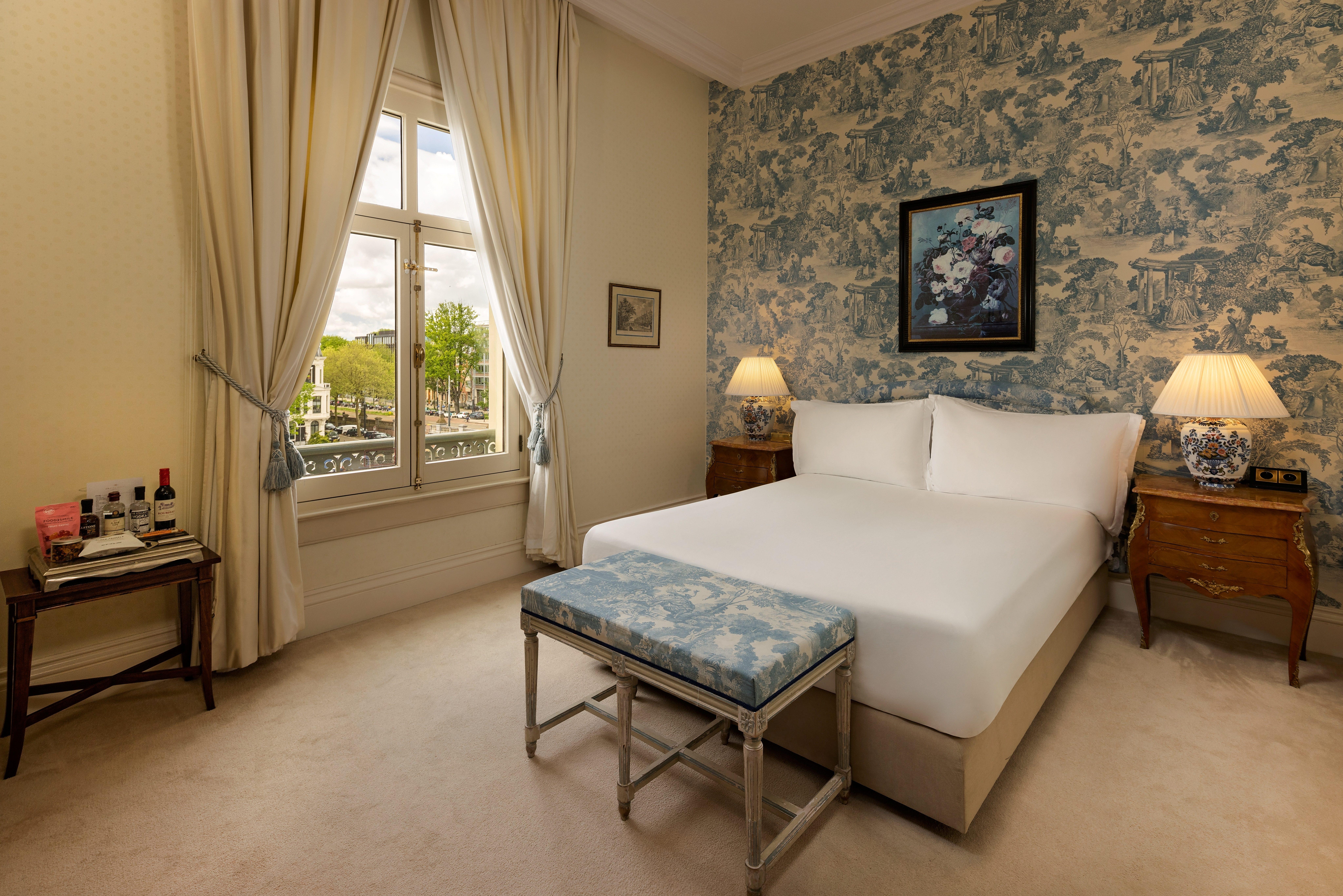 King Premium River View guestroom showcasing classic French elegance and sweeping Amstel views