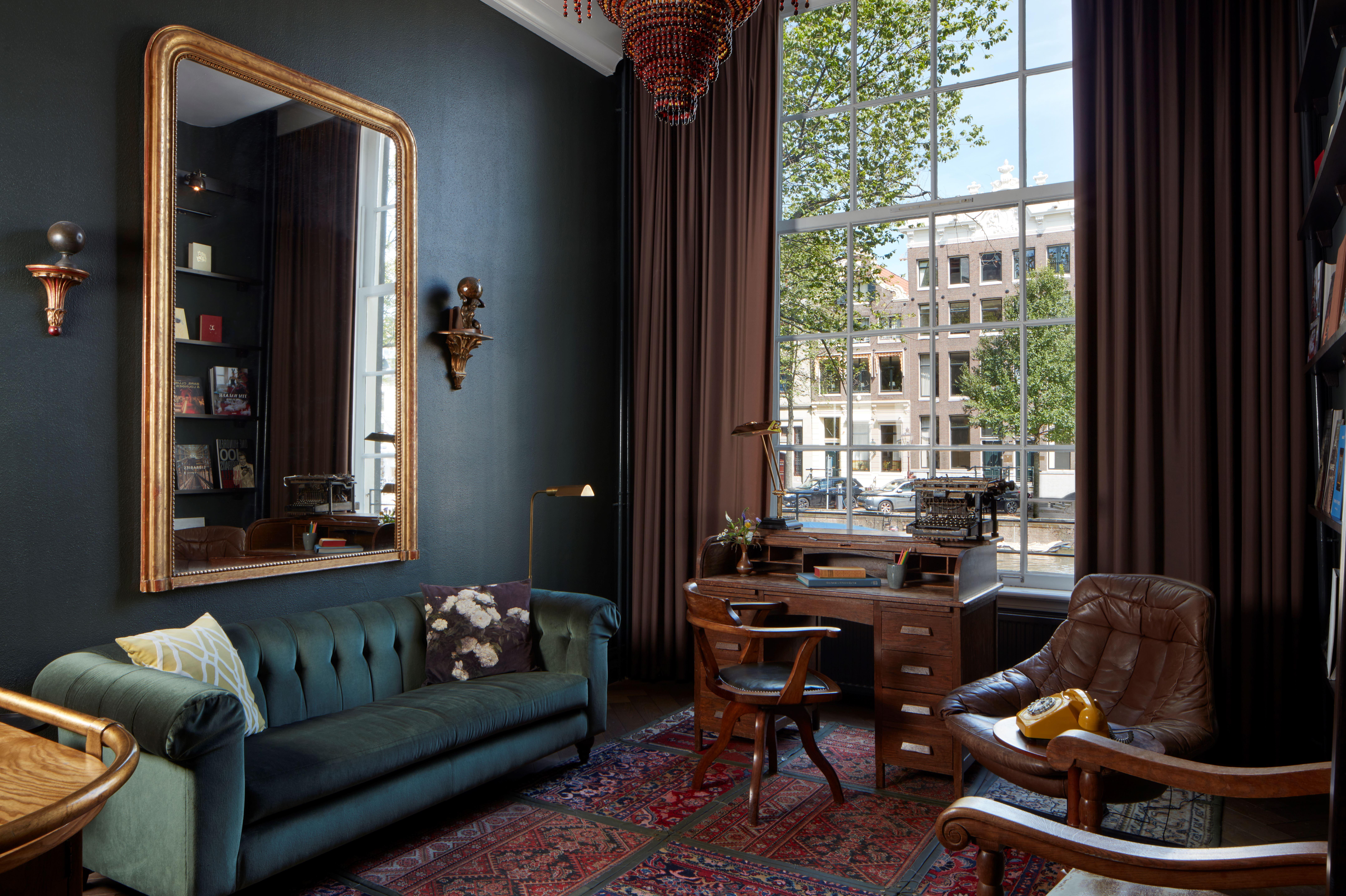 Book Collector's Suite featuring library wall of antique volumes, private entrance, and eclectic Dutch design
