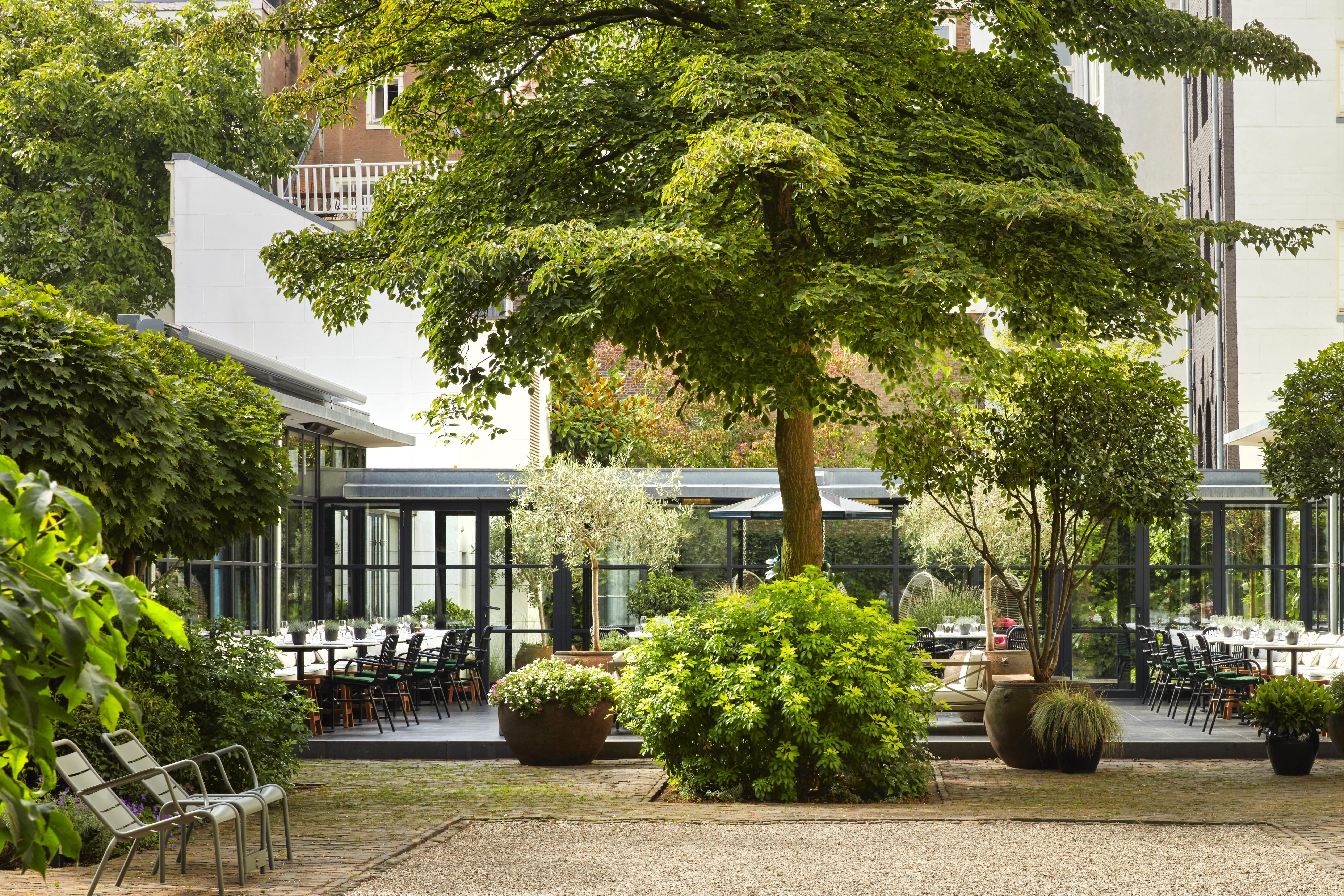 Tranquil private inner courtyard gardens hidden between Prinsengracht and Keizersgracht canal houses
