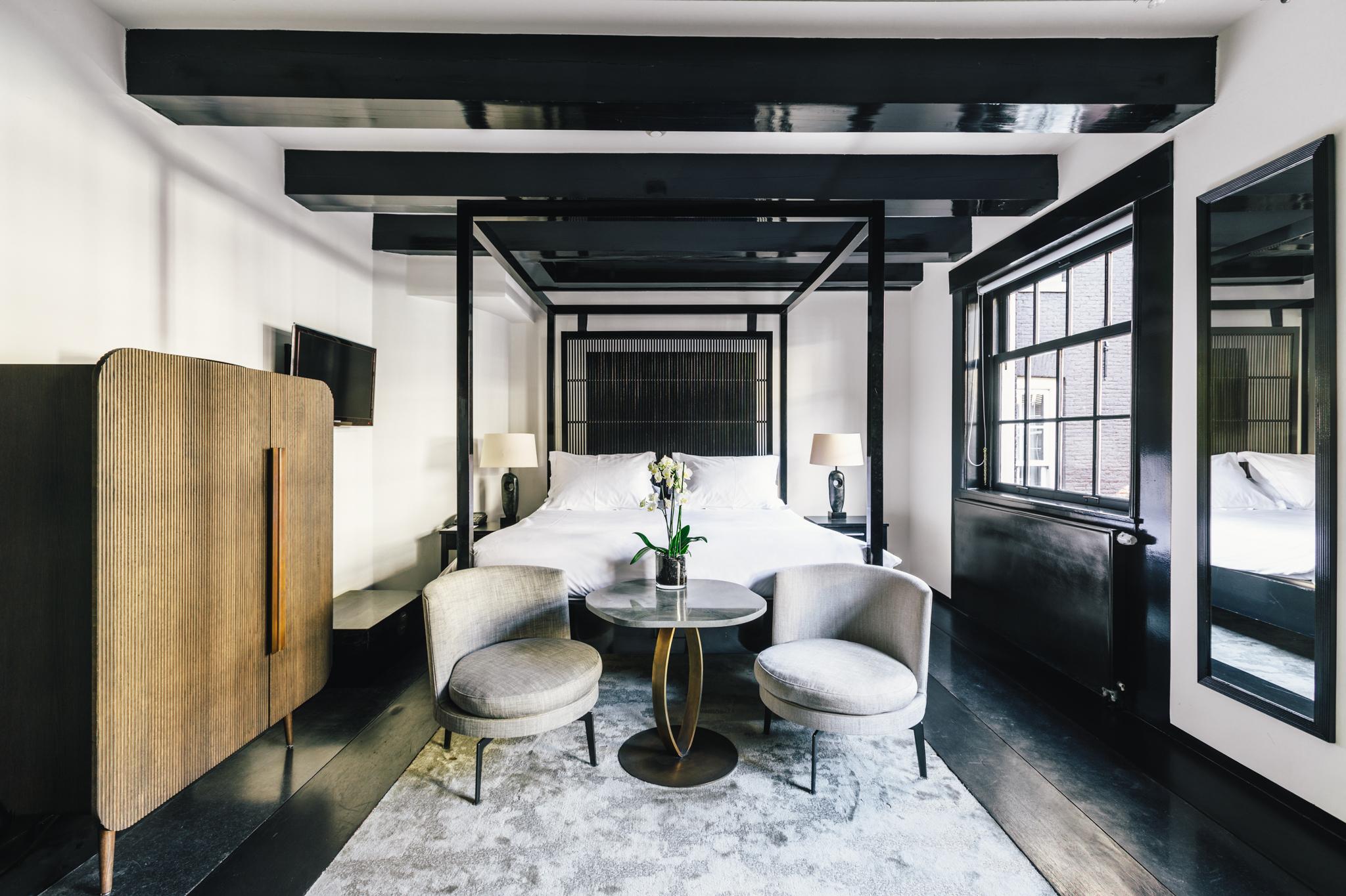 Luxury Double Room showcasing warm Amber style palette, exposed timber beams, and plush bedding