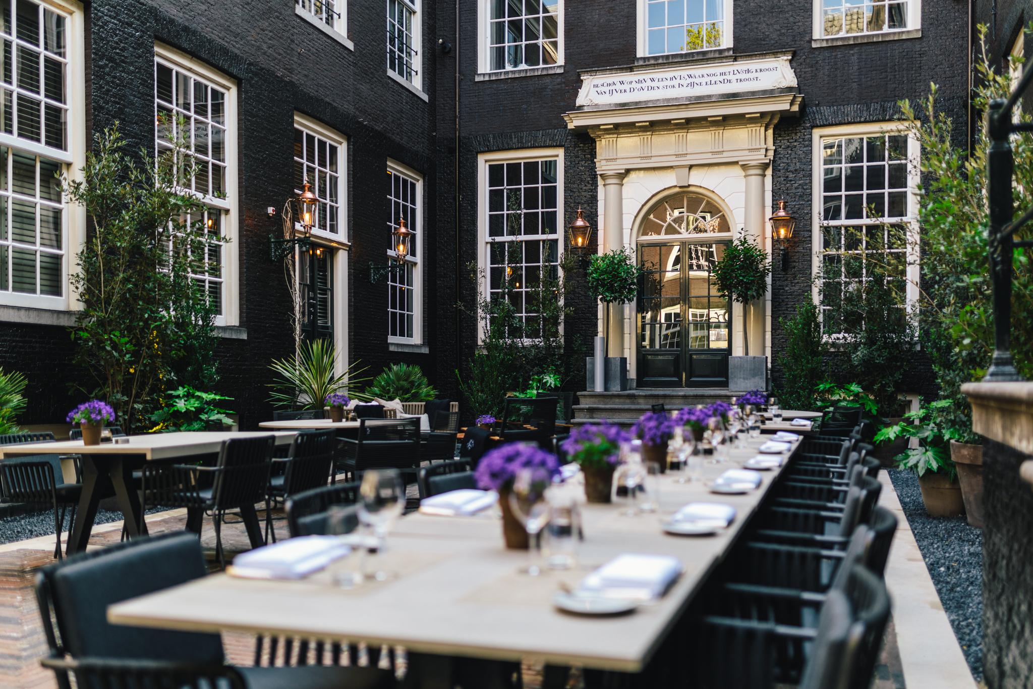 Secluded private inner courtyard garden terrace of The Dylan surrounded by historic brick walls
