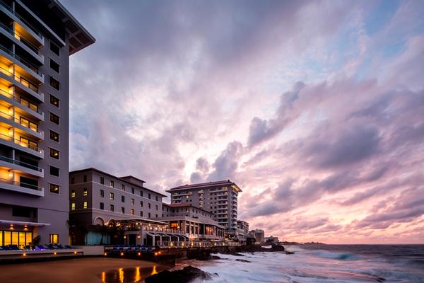 Condado Vanderbilt Hotel historic Spanish Revival architecture and oceanfront towers at sunset