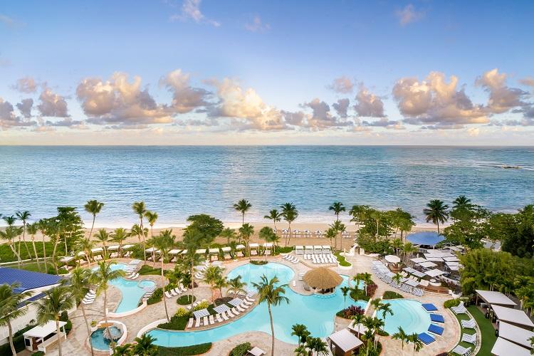 Fairmont El San Juan Hotel sparkling signature swimming pools and Isla Verde beachfront palms