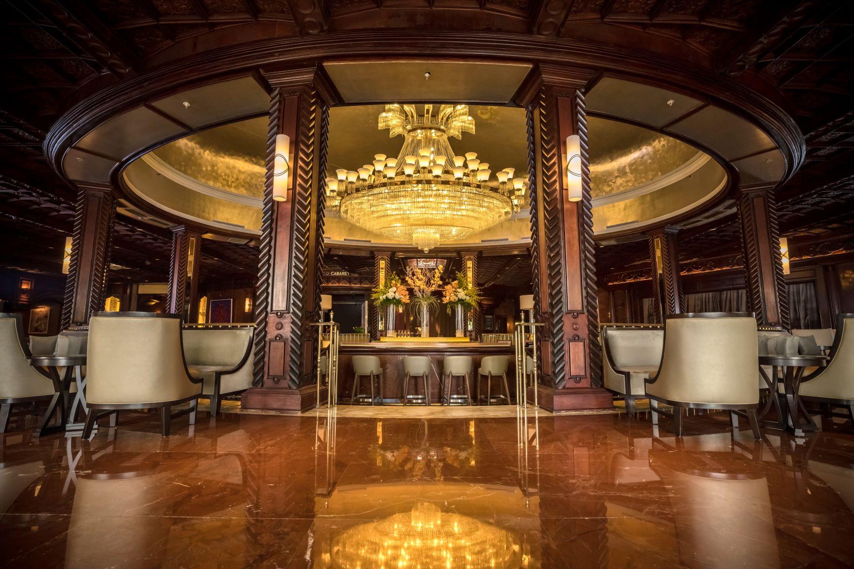Iconic 4,000-pound crystal chandelier and hand-carved mahogany ceiling at The Chandelier Bar