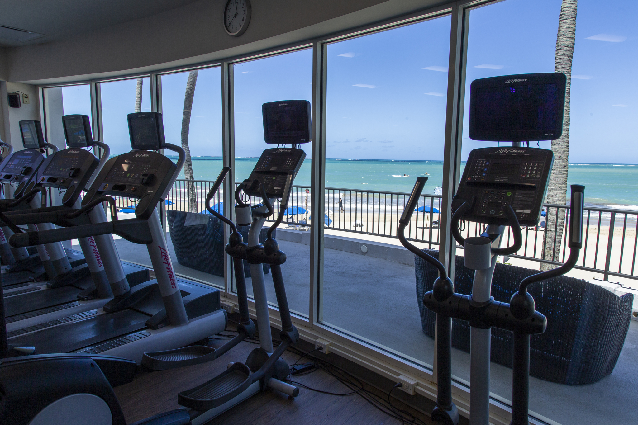 State-of-the-art 24-hour fitness center overlooking the resort pool and tropical foliage
