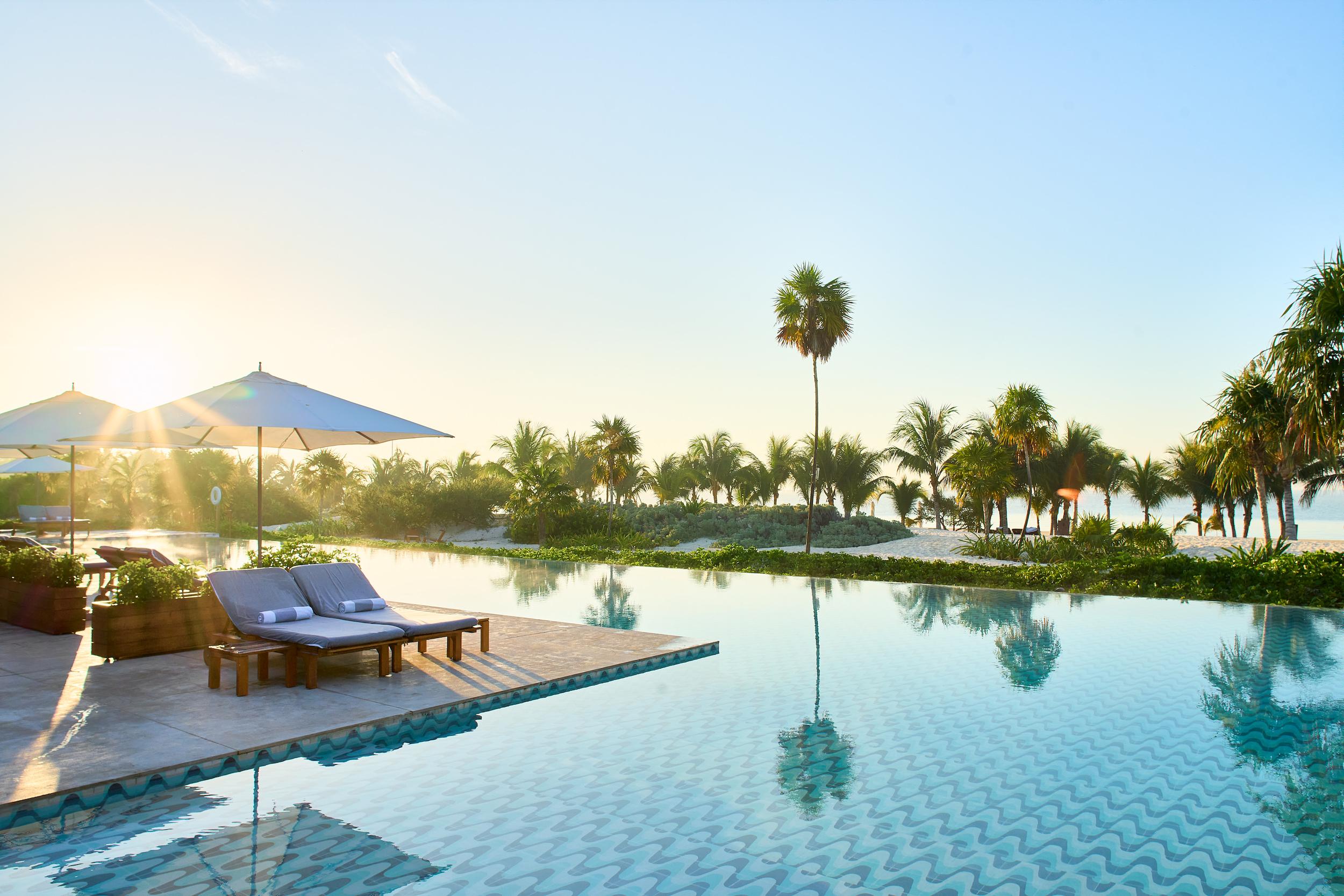 Main infinity pool at sunrise facing the Caribbean Sea