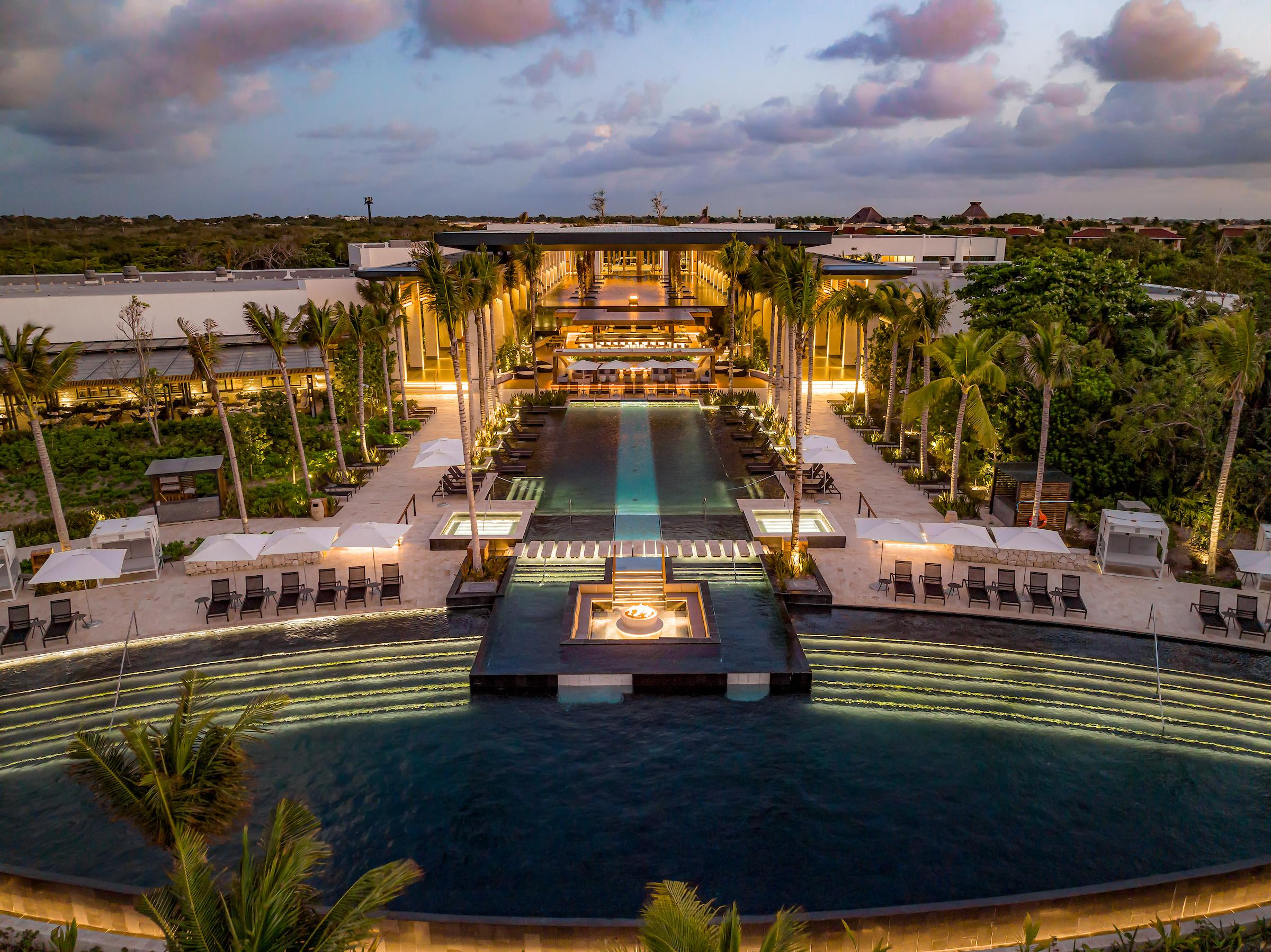 Conrad Tulum main swimming pool illuminated at dusk