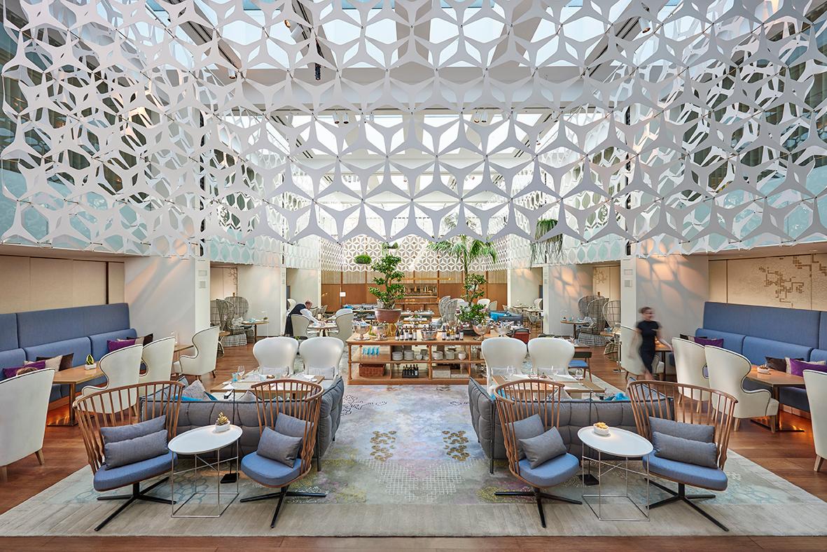 Blanc Restaurant beneath soaring glass atrium at Mandarin Oriental Barcelona