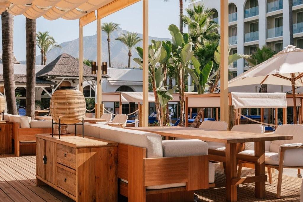 Outdoor dining terrace at ME Marbella restaurant overlooking gardens