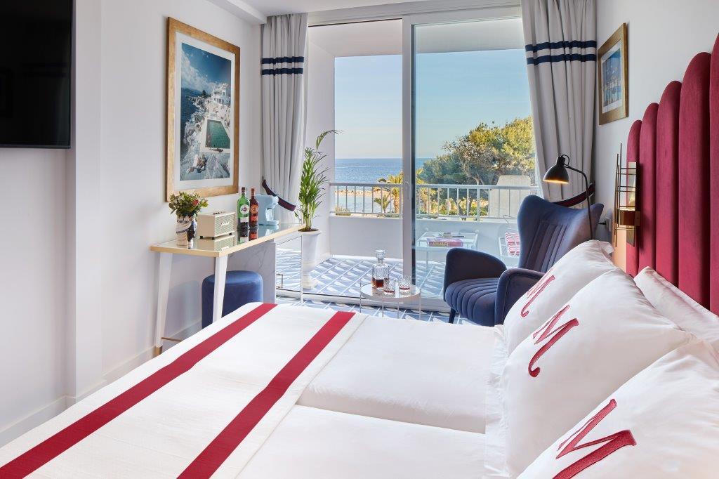 Deluxe room interior with private balcony at Mongibello Ibiza