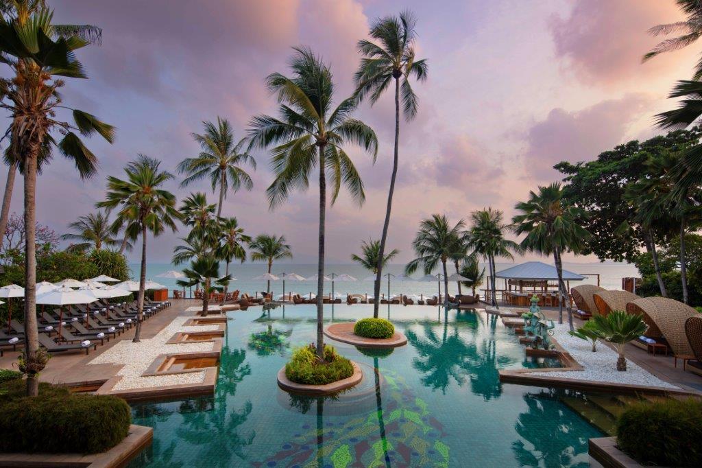 Resort beachfront swimming pool at dusk overlooking the ocean
