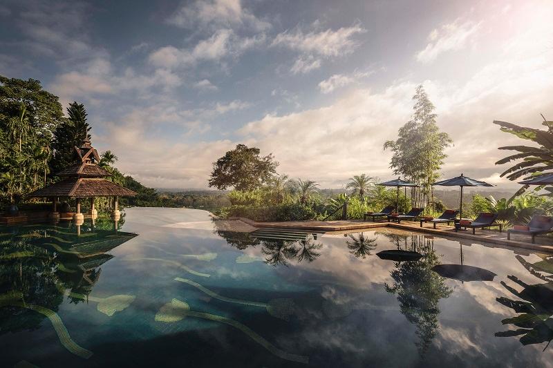 Infinity swimming pool at dawn overlooking three countries