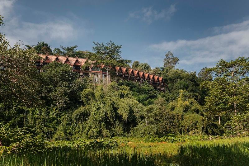 Lush hillside grounds and traditional Lanna architecture
