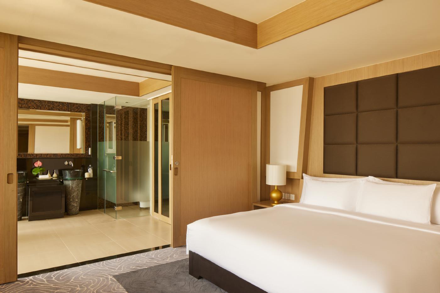 Two Bedroom Serenity Suite lavish living salon with panoramic floor-to-ceiling Bangkok views