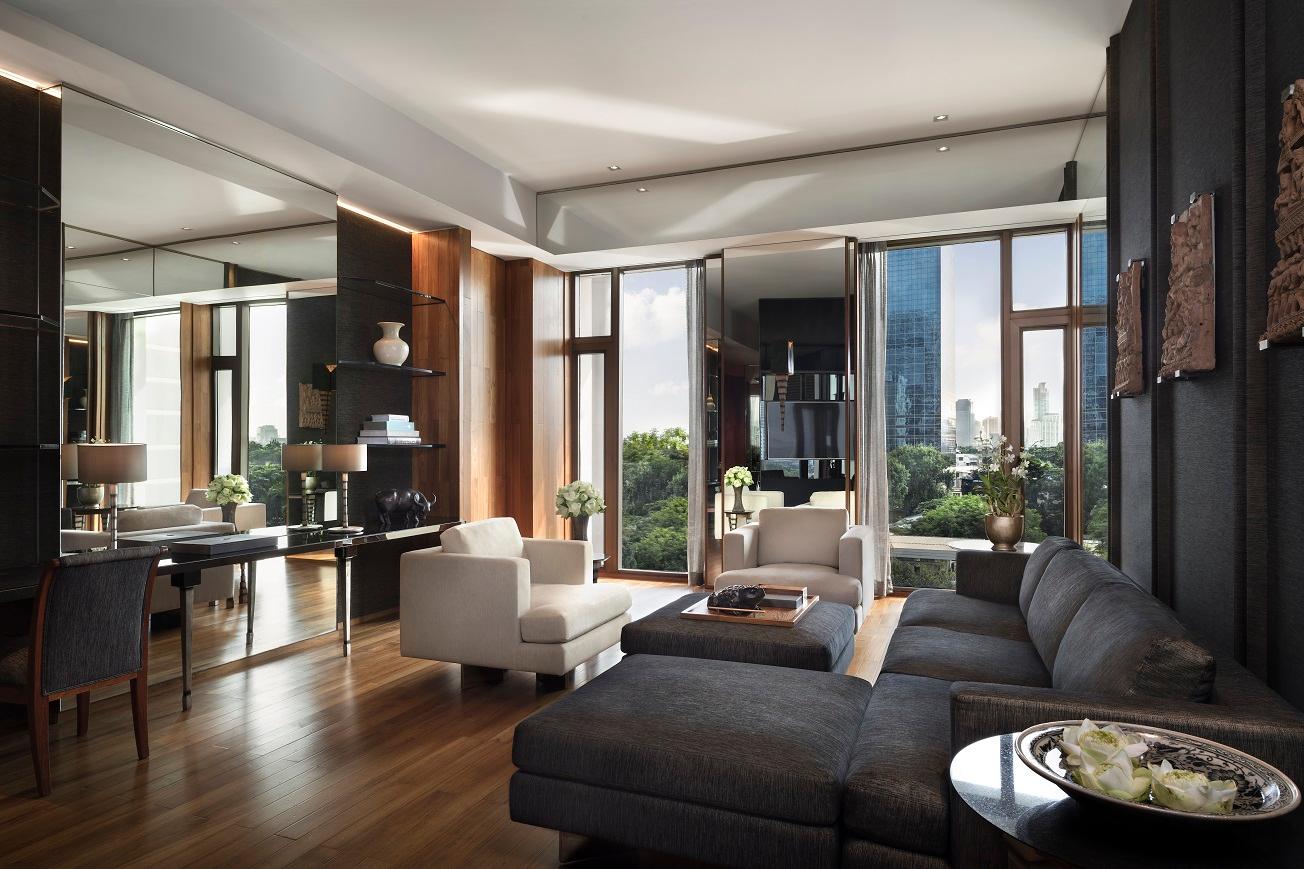 Club Suite spacious living salon featuring dark timber paneling and handwoven Thai silks