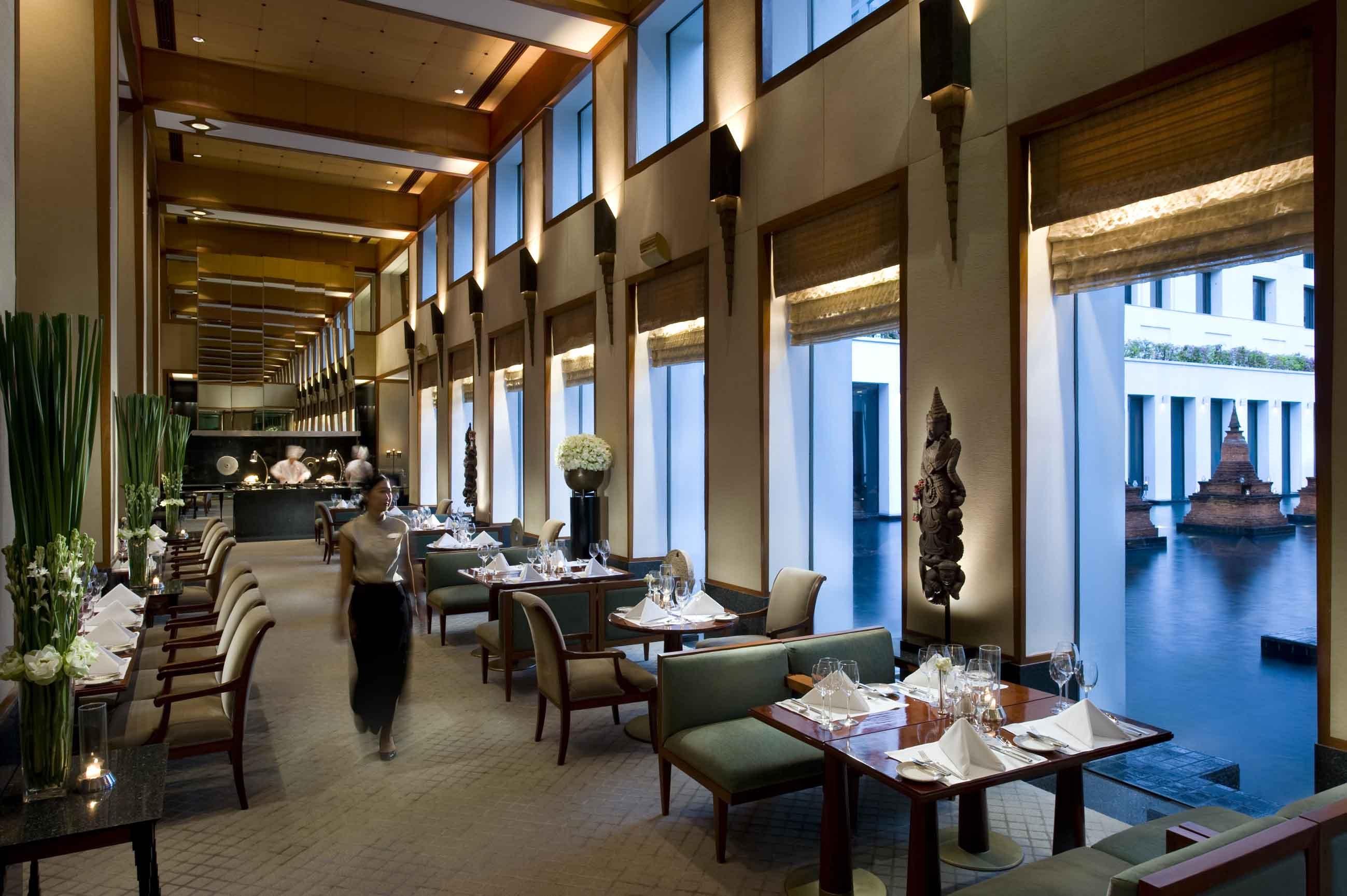 The Colonnade dining room overlooking the reflection pond and floating chedi sculptures