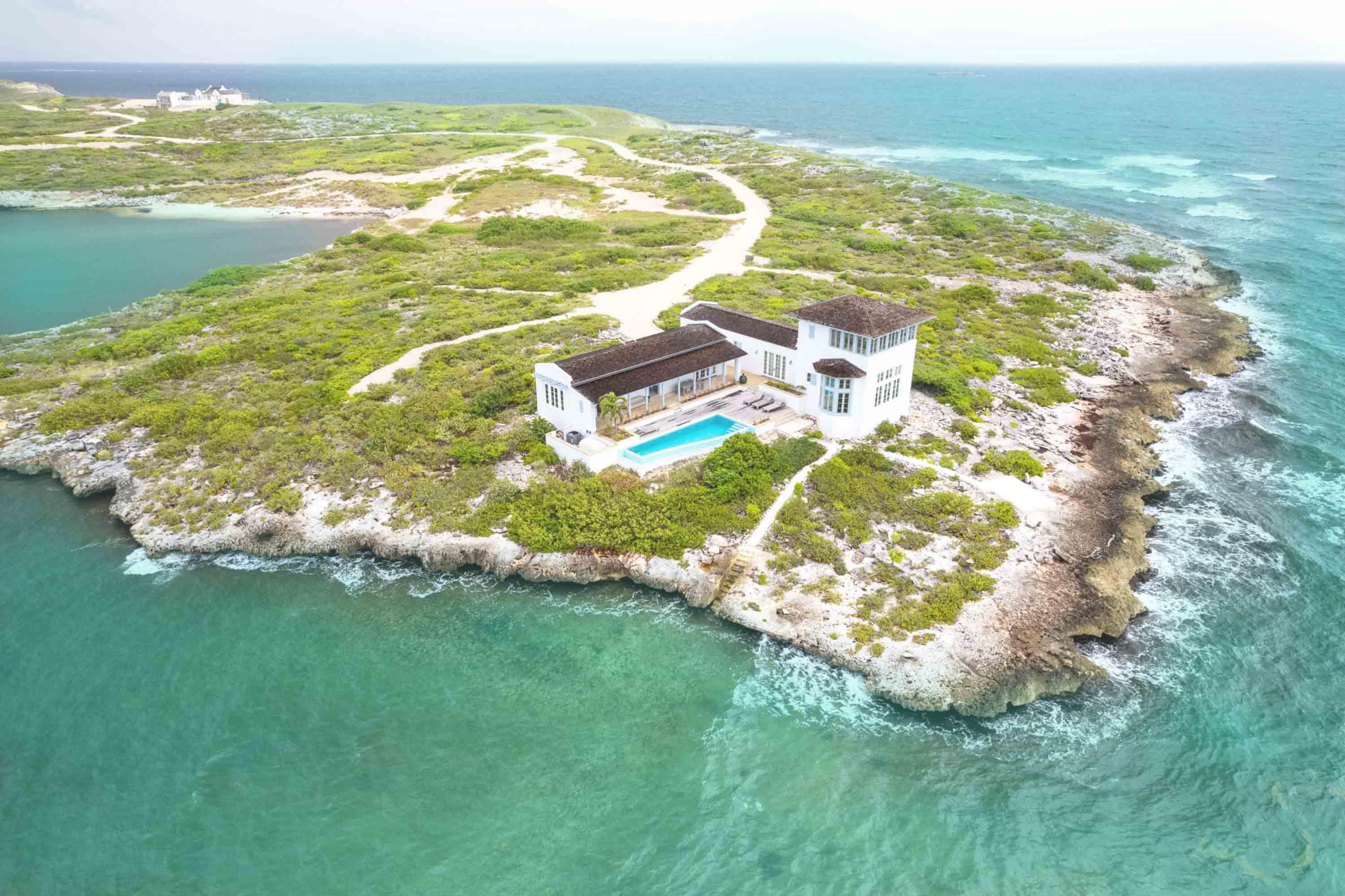 Aerial view of 1100-acre private island Ambergris Cay and deserted white sand beaches