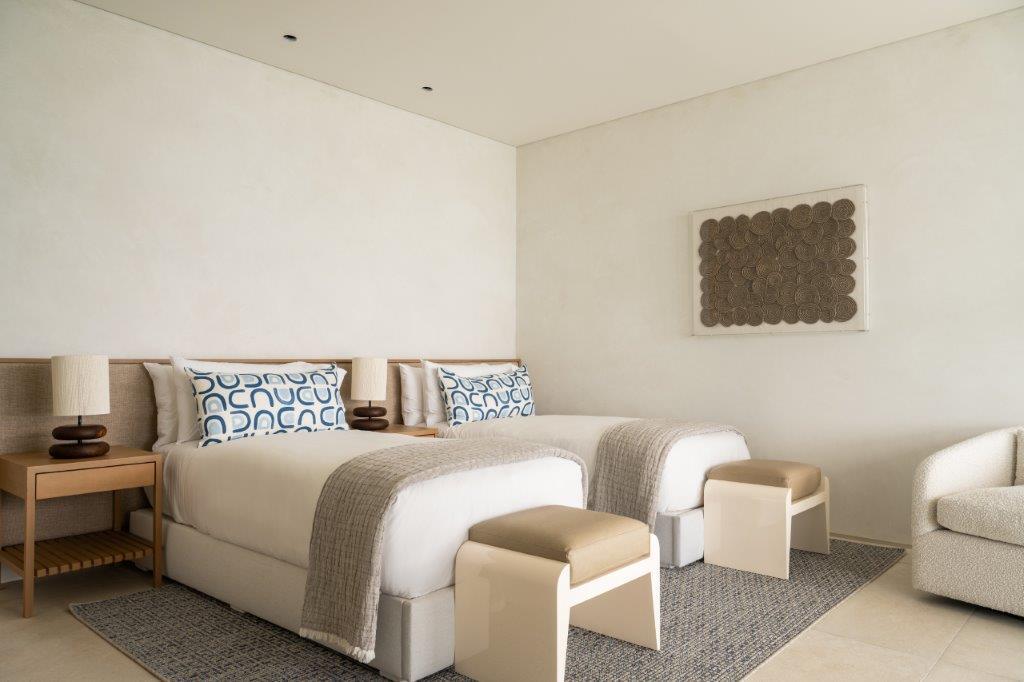 Airy contemporary master bedroom suite with sweeping turquoise ocean vistas