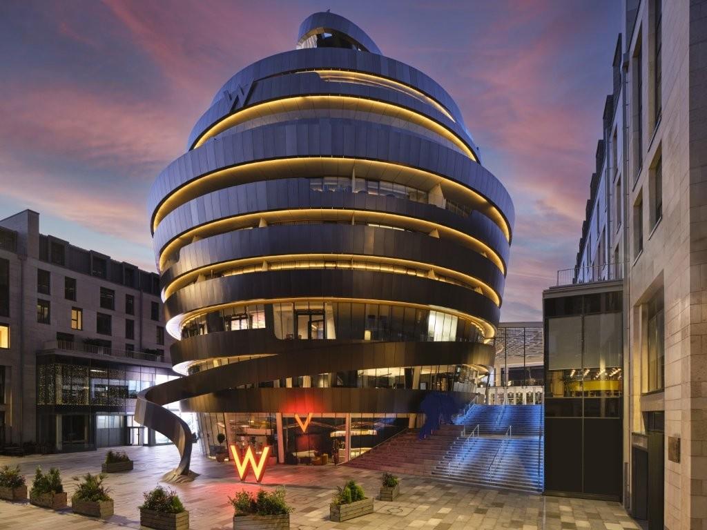 W Edinburgh Striking Bronze Ribbon Building Illuminated at Night in St James Quarter