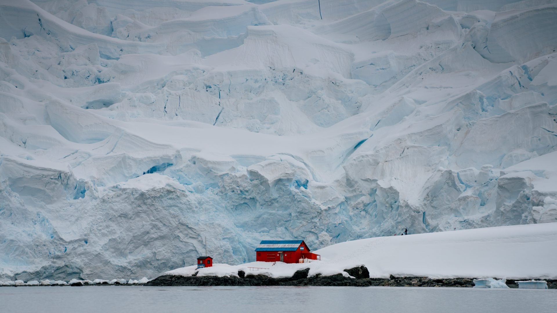Zodiac expedition boat cruising through glassy mirror waters in Paradise Harbour Antarctica
