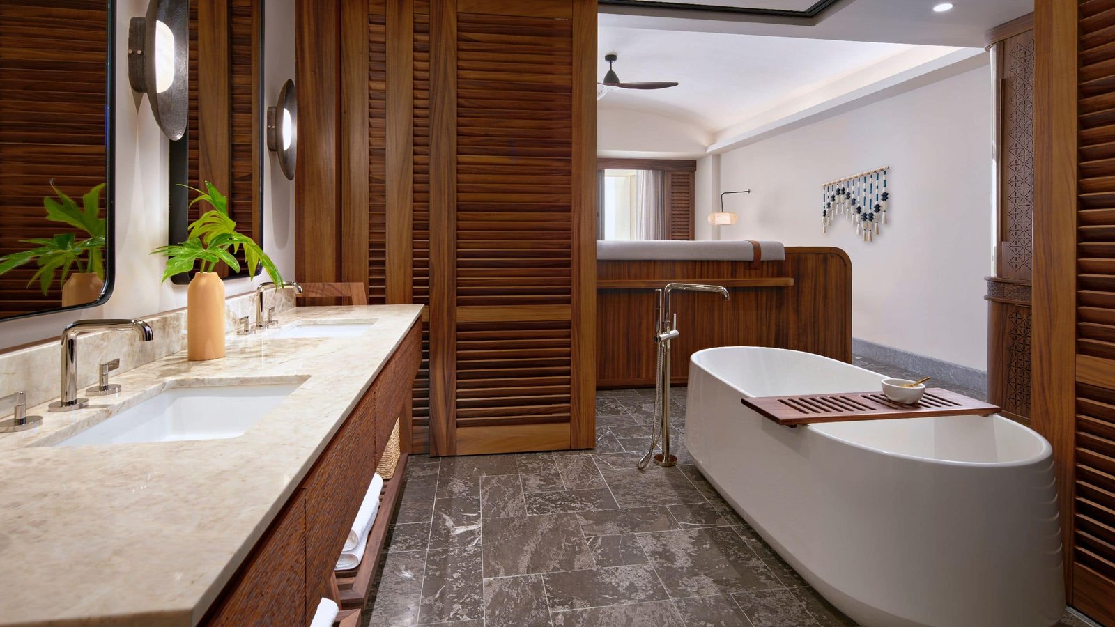Spa-inspired bathroom with freestanding soaking tub and double marble vanities