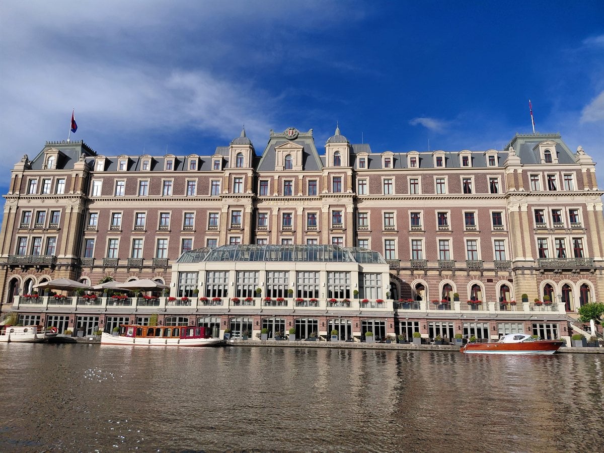 Evening canal dinner cruise through illuminated Amsterdam waterways