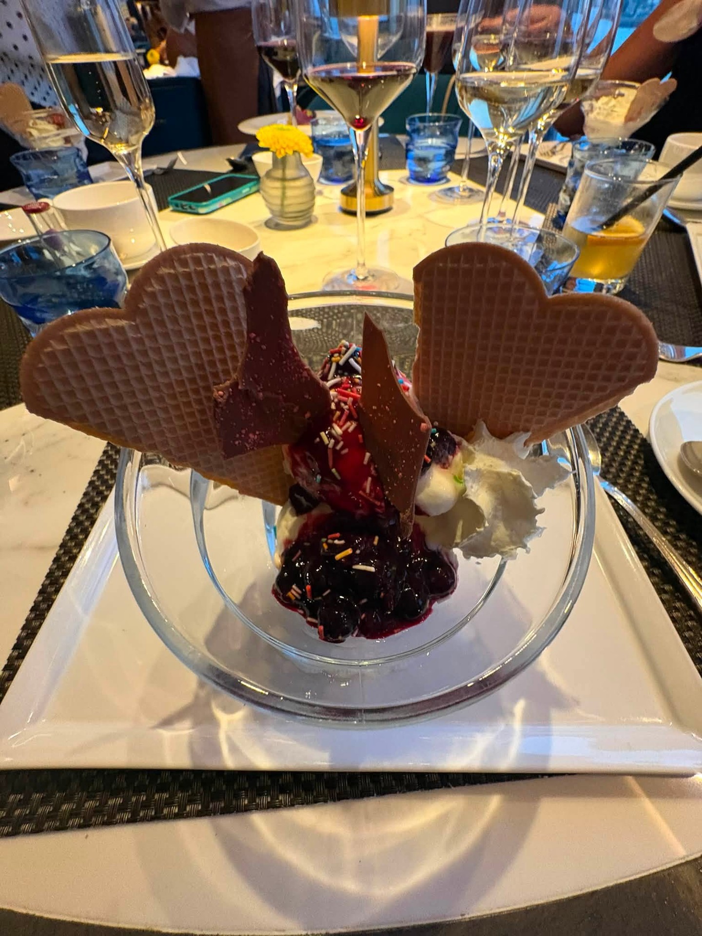 Decadent gourmet dessert bowl with heart-shaped wafers and fresh berries on Riverside Luxury Cruises