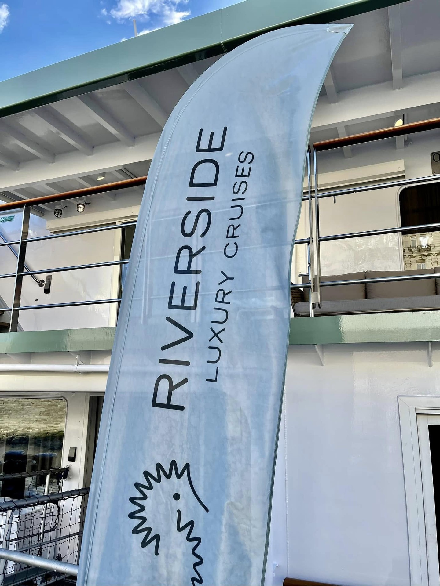 Riverside Luxury Cruises branded banner at the boarding gangway