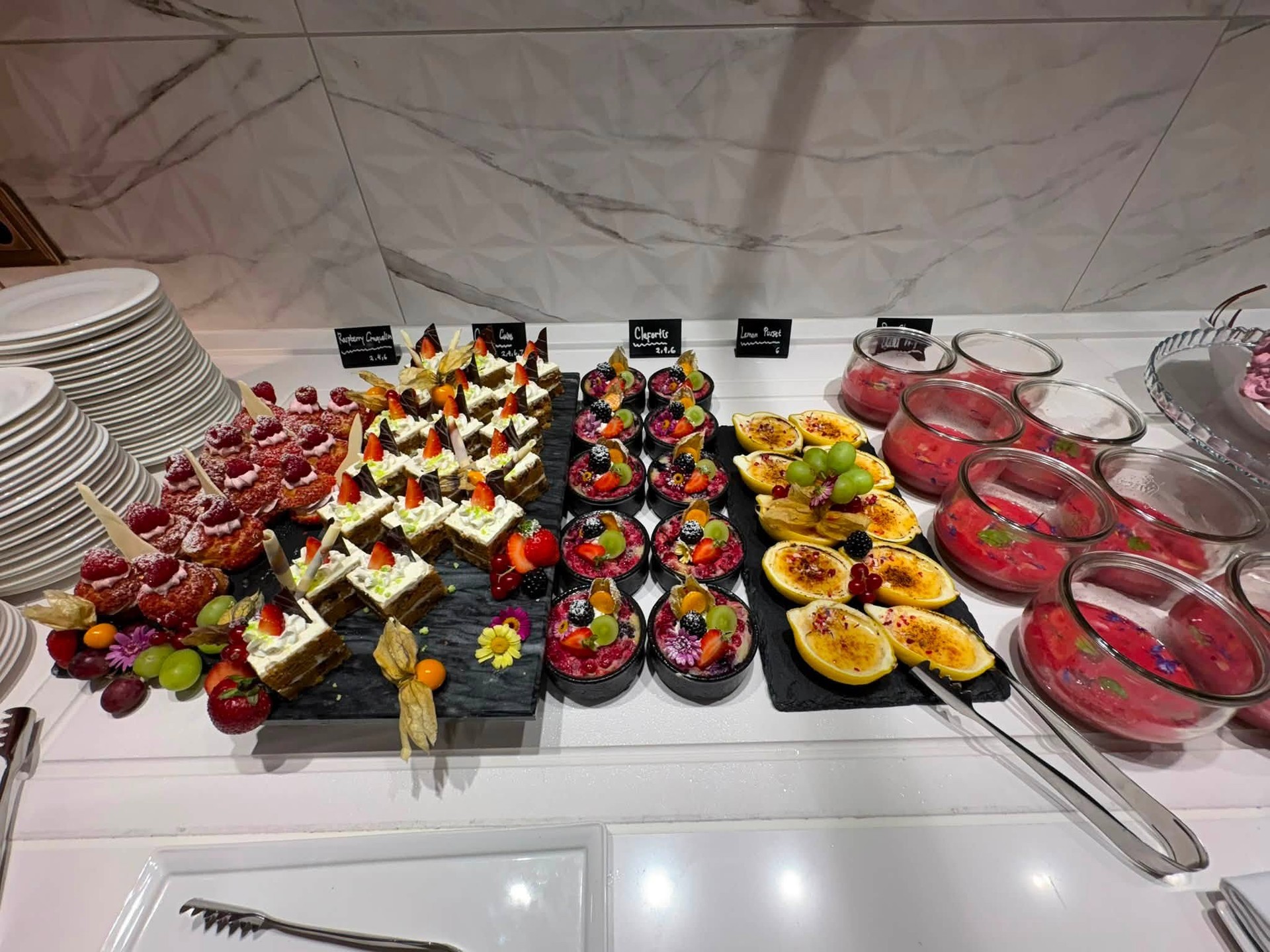 Colorful dessert buffet display with fruit tartlets and chocolate mousse on Riverside Debussy