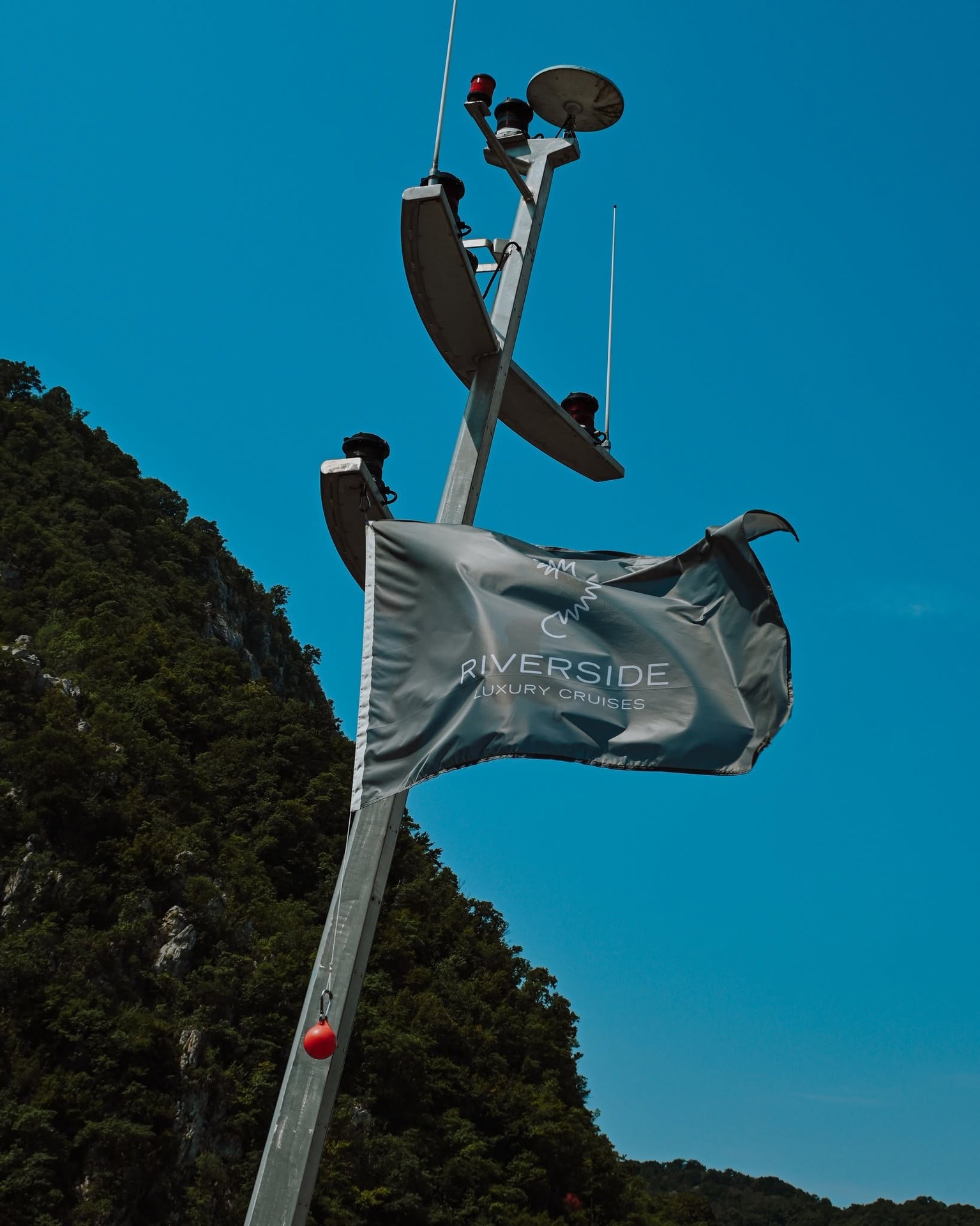 Riverside Luxury Cruises ship mast and navigational equipment against clear European skies