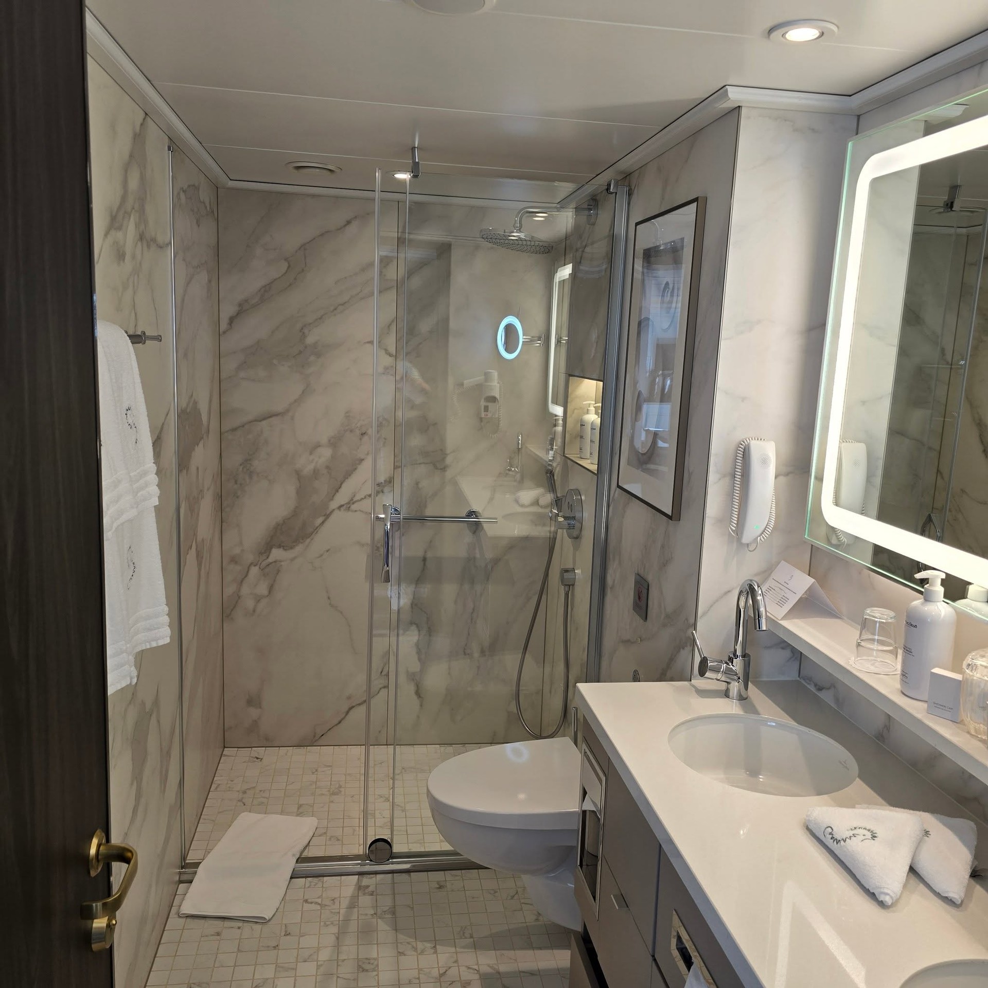 Master marble bathroom with glass walk-in rainfall shower on Riverside Debussy