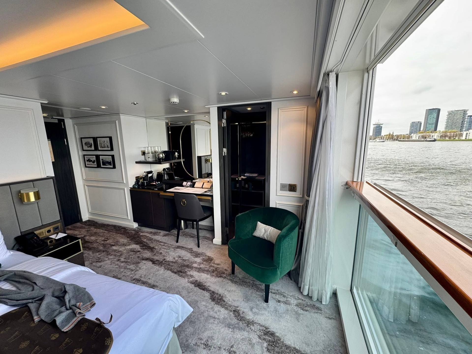 Wide-angle view of suite with drop-down panoramic balcony window facing river on Riverside Debussy