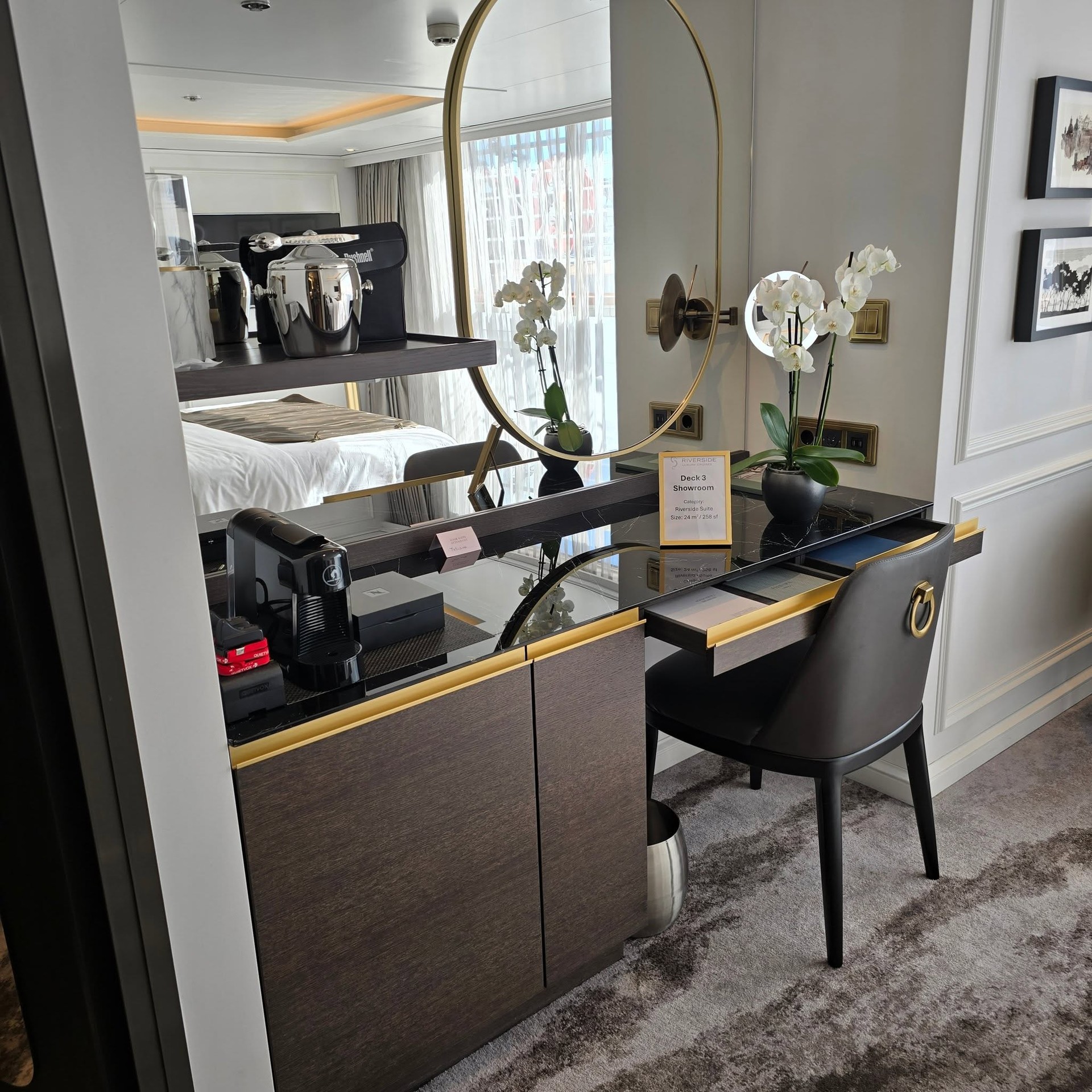 Suite vanity makeup desk with fresh orchid and view to King bed on Riverside Debussy