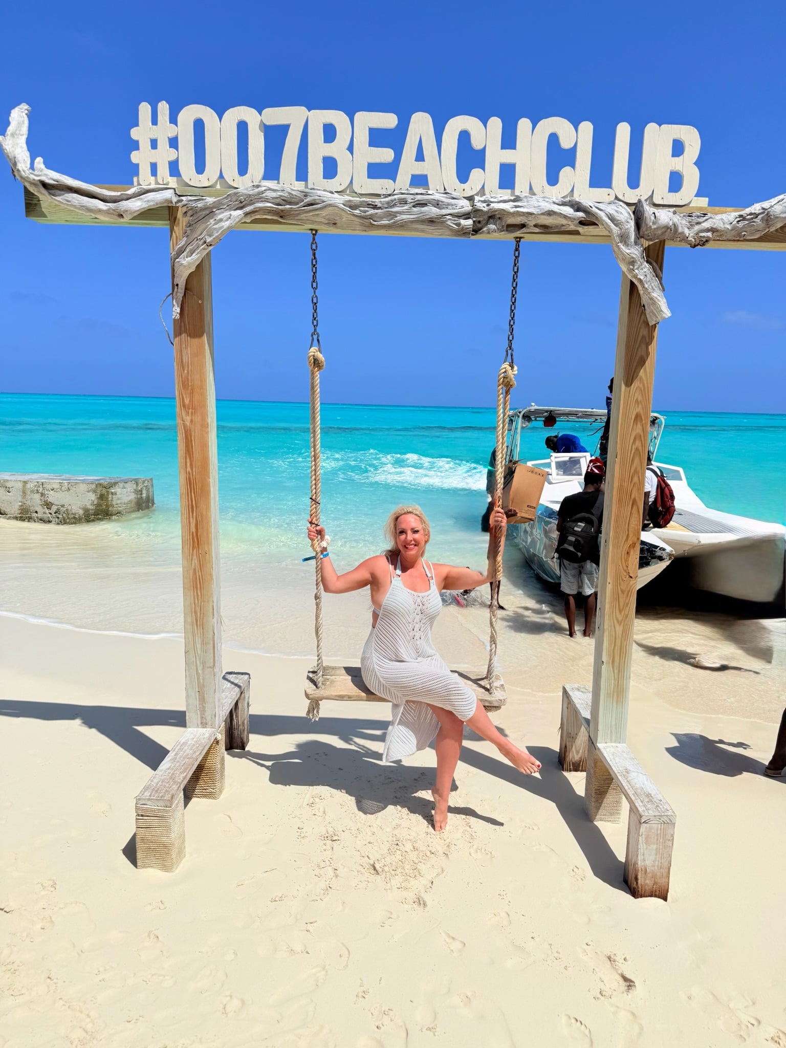 Aimee Byrd on a tropical ocean swing in crystal turquoise waters of San Salvador Bahamas